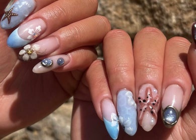 Elegant oceanic-themed nail art at HT Studio, Glasgow, Scotland, GB showcasing starfish and floral designs.