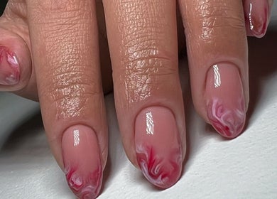 Intricate marble nail art at HT Studio, Glasgow, Scotland, GB, showcasing vibrant pink and white swirls.