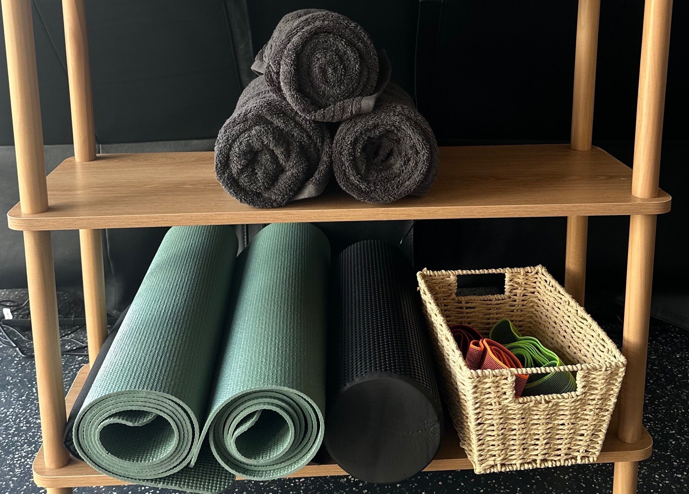 Yoga mats, towels, and accessories on a wooden shelf at CORE Recovery, Warrnambool, Victoria, AU.