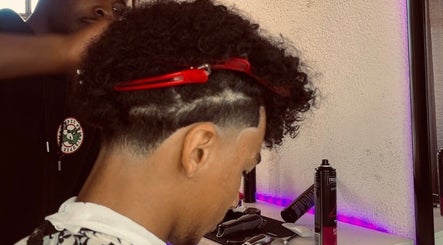 Hair stylist at Faded By Emmy in Cape Town, Western Cape, ZA giving a stylish haircut with precision and care.