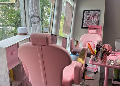 Stylish pink salon chairs at Slayed By Becca in Boston, Massachusetts, US, offering a luxurious beauty experience.