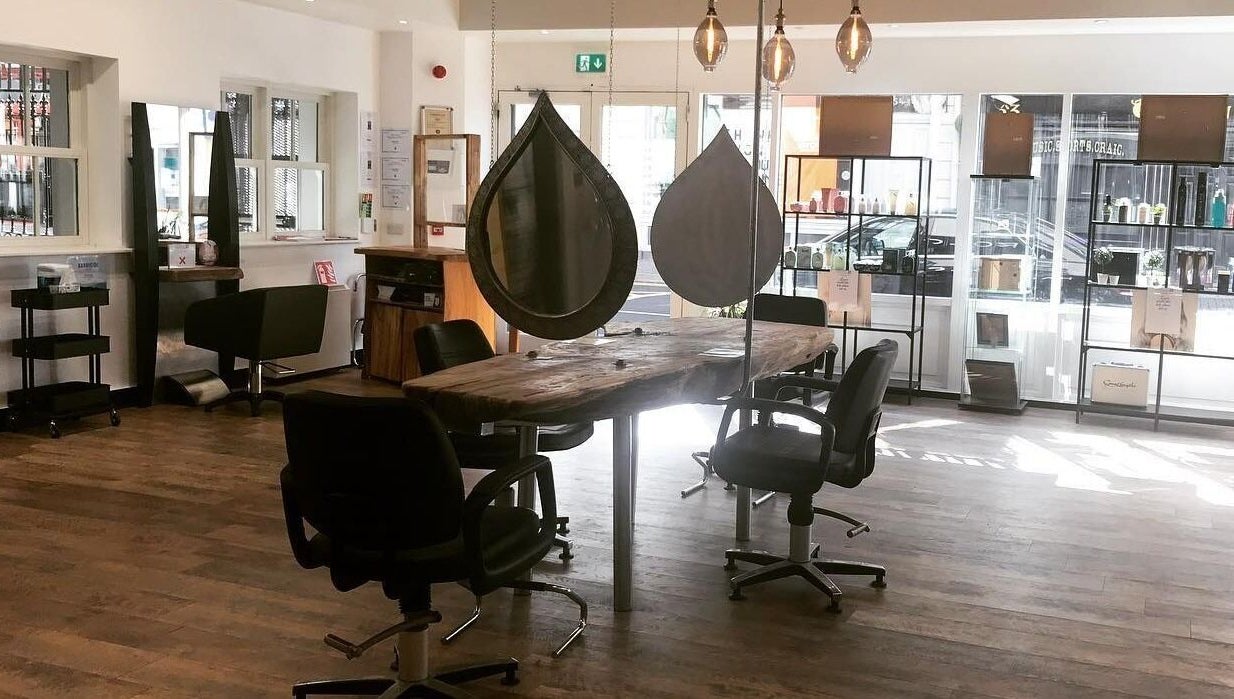 Chic styling area with rustic wood table at Hairology, Carlow, County Carlow, IE.