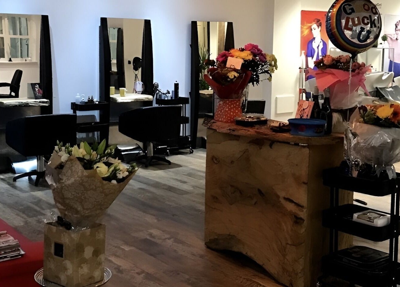 Elegant interior of Hairology in Carlow, County Carlow, IE with styling stations and floral decor.