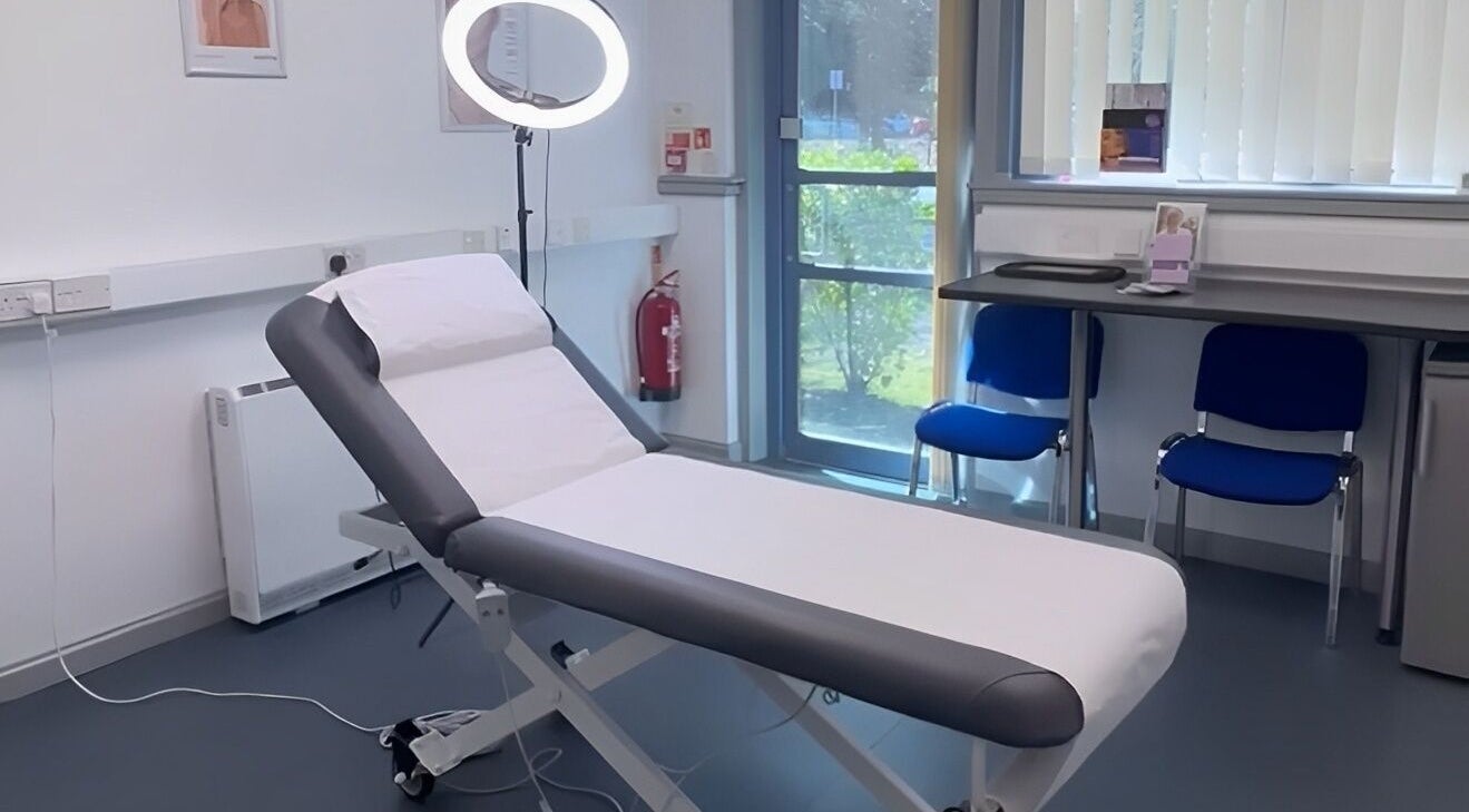 Modern treatment room at RTB Aesthetics, Cardiff, Wales, GB, featuring a professional massage bed and well-lit interior.