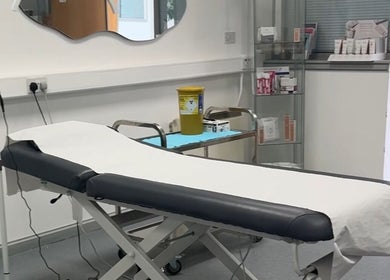 Modern treatment room at RTB Aesthetics, Cardiff, Wales, GB, featuring a comfortable therapy bed and relaxation ambiance.