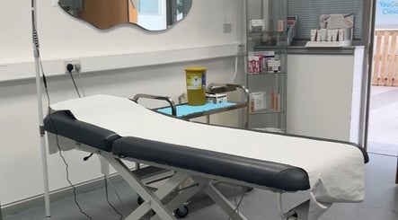 Modern treatment room at RTB Aesthetics, Cardiff, Wales, GB, featuring a comfortable therapy bed and relaxation ambiance.