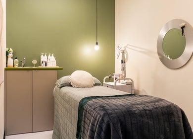 Cozy treatment room at Sharkra Medi Spa & Laser Clinic, Hobart, Tasmania, AU, featuring a plush bed and serene decor.