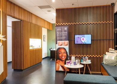 Elegant lobby of Sharkra Medi Spa & Laser Clinic, Hobart, Tasmania, AU with modern wood paneling and cozy seating.