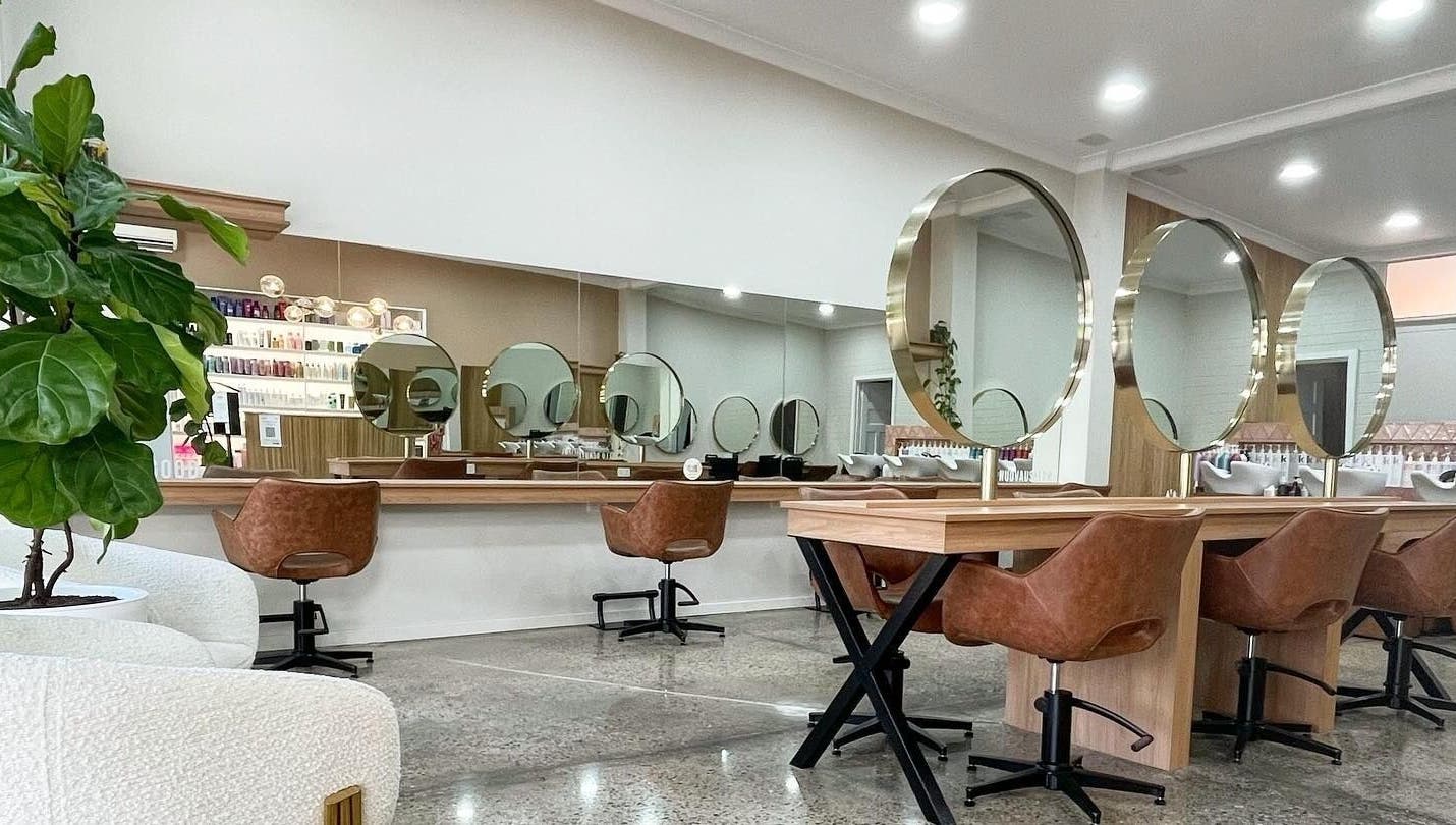 Elegant salon interior with round mirrors at Nuova U Salon, Mount Pleasant, Western Australia, AU.