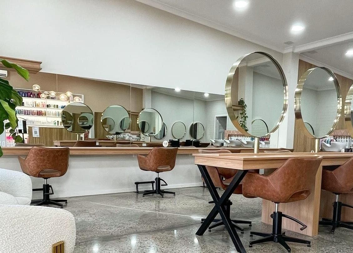 Elegant salon interior with round mirrors at Nuova U Salon, Mount Pleasant, Western Australia, AU.