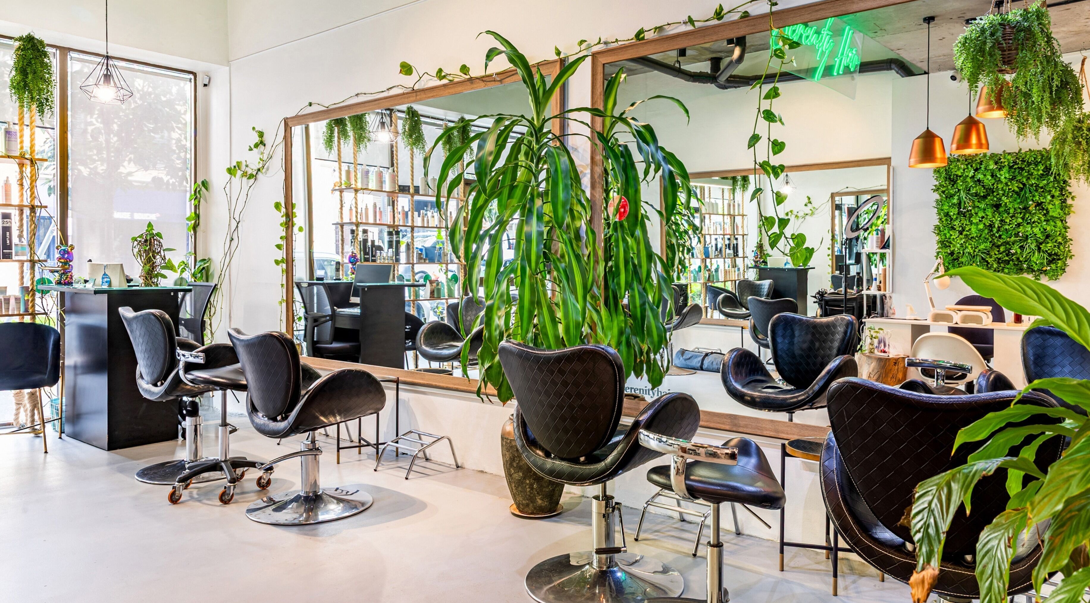 Serenity Hair & Co salon in Surry Hills, New South Wales, AU, features elegant chairs and lush greenery décor.