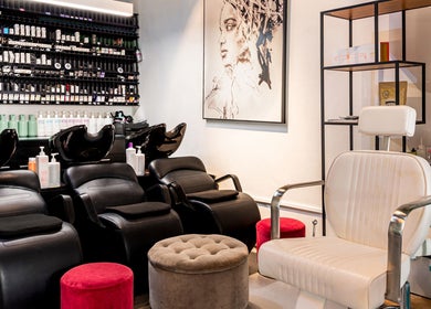 Elegant salon interior at Serenity Hair & Co in Surry Hills, New South Wales, AU with stylish seating and art.