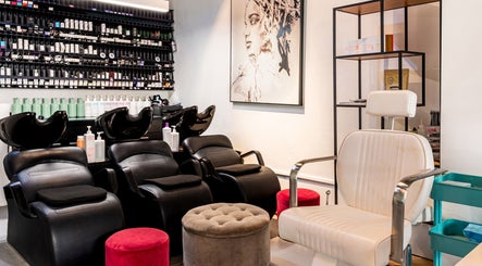 Elegant salon interior at Serenity Hair & Co in Surry Hills, New South Wales, AU with stylish seating and art.