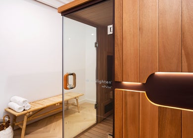 Luxurious sauna room at La Cure, Caringbah South, New South Wales, AU with wooden interior and seating.