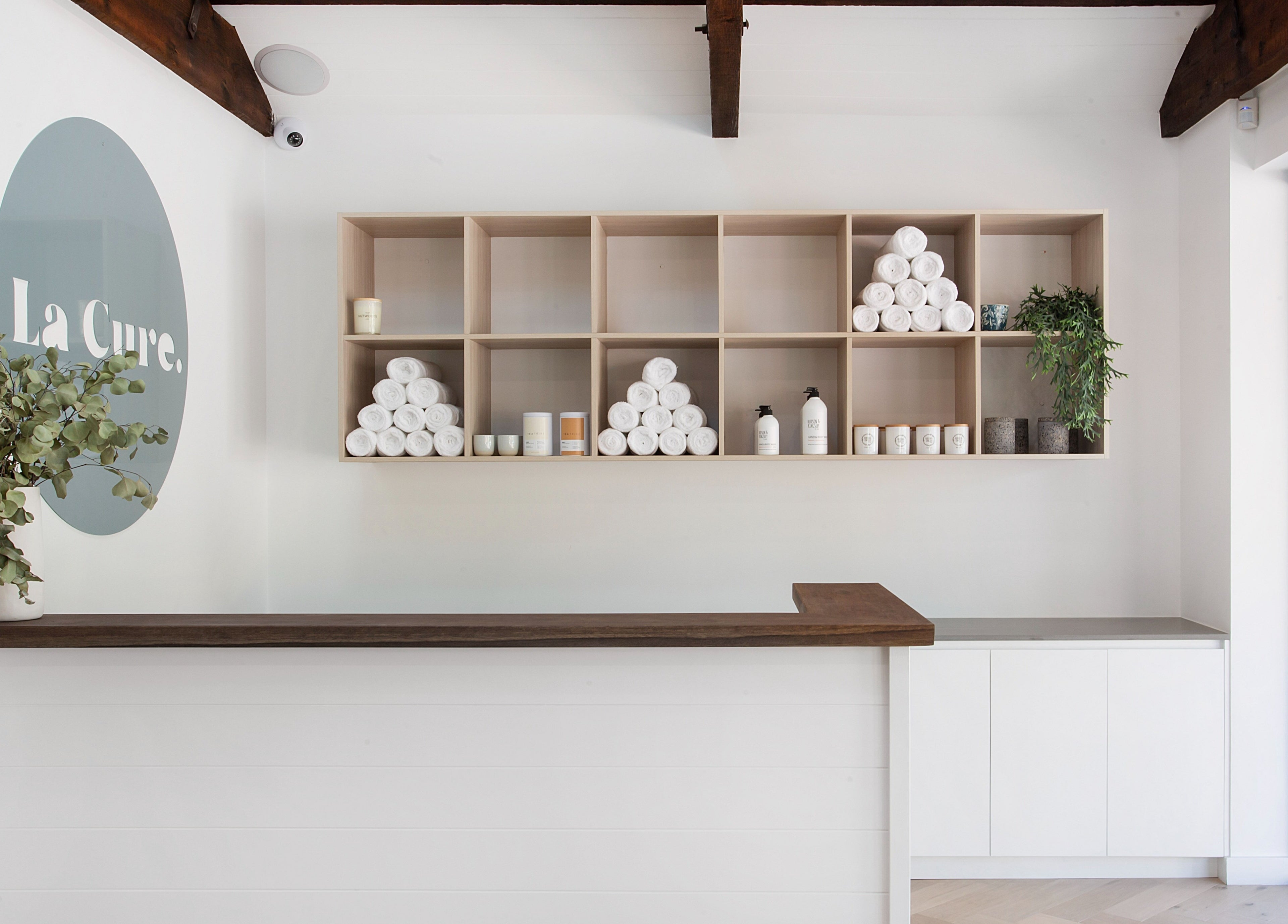 Reception area at La Cure with shelves of towels in Caringbah South, New South Wales, AU.