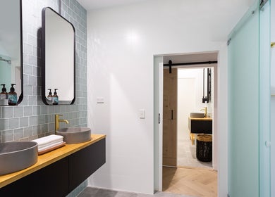 Modern bathroom vanity at La Cure, Caringbah South, NSW, AU, featuring dual sinks and stylish mirrors.