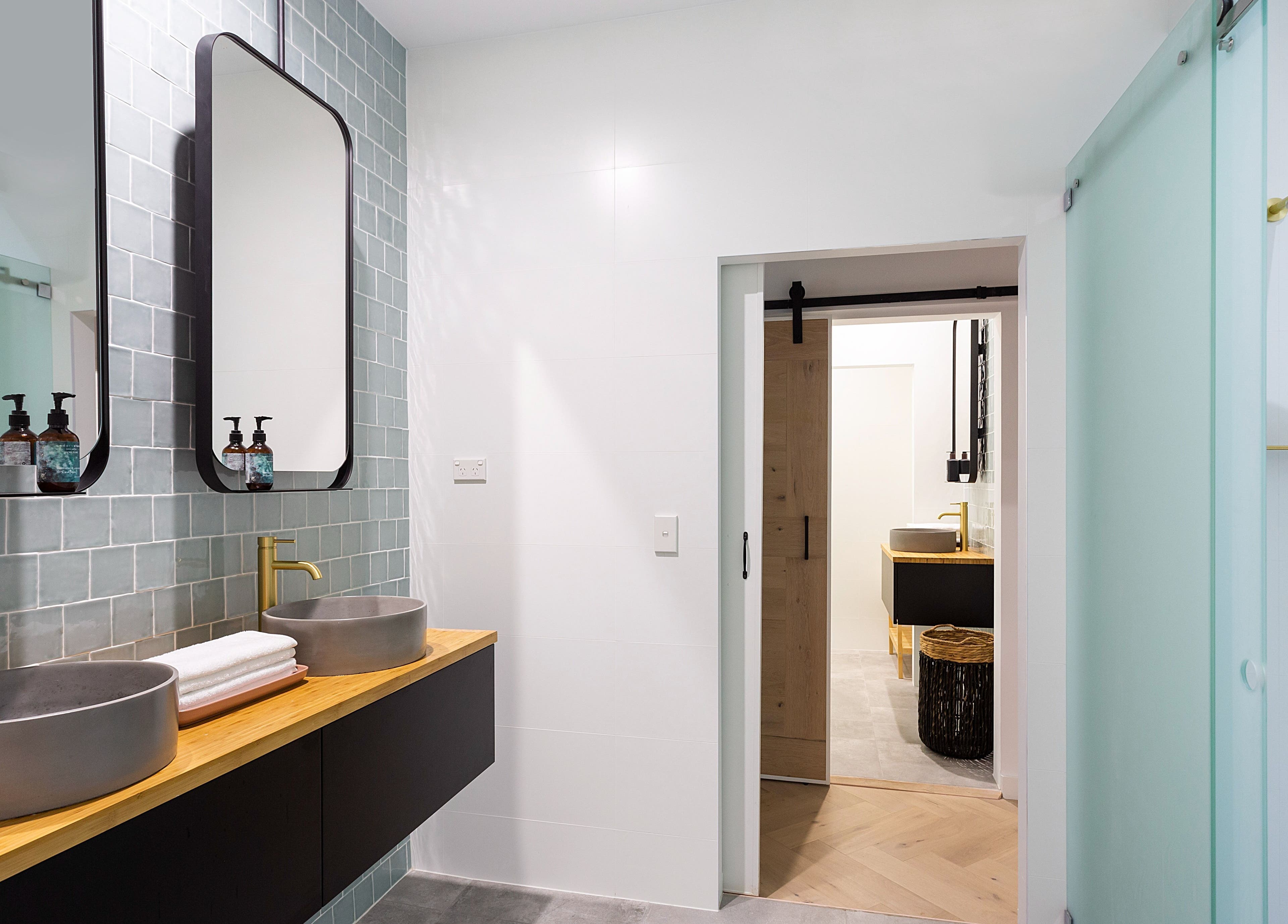 Modern bathroom vanity at La Cure, Caringbah South, NSW, AU, featuring dual sinks and stylish mirrors.