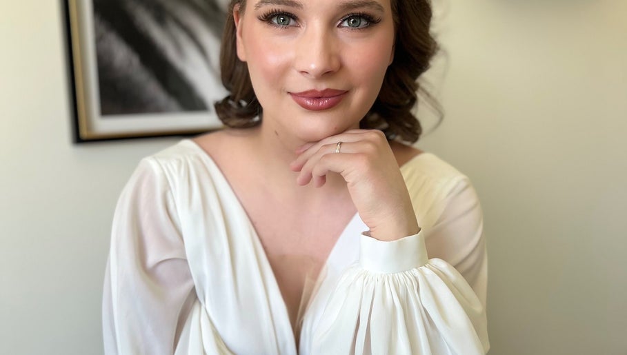 Woman with elegant makeup by Stasya, Calgary, Alberta, CA, looking radiant in a soft white gown.