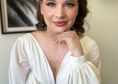 Woman with elegant makeup by Stasya, Calgary, Alberta, CA, looking radiant in a soft white gown.