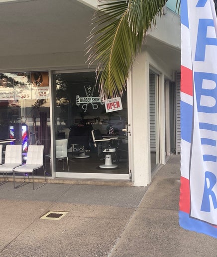 Exterior of The Cutler Barbershop Currimundi with chairs and barber flag in Currimundi, Queensland, AU.