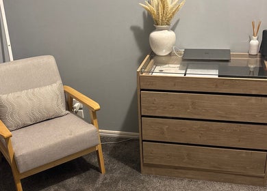 Comfortable lounge area at Beauty Lounge By Lil, Meringandan, Queensland, AU featuring a soft chair and dresser.
