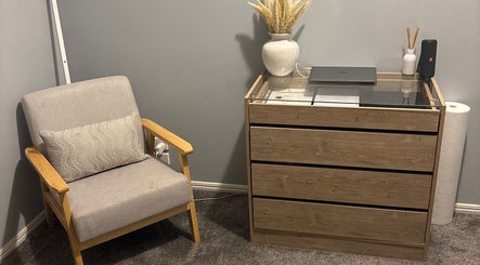 Comfortable lounge area at Beauty Lounge By Lil, Meringandan, Queensland, AU featuring a soft chair and dresser.