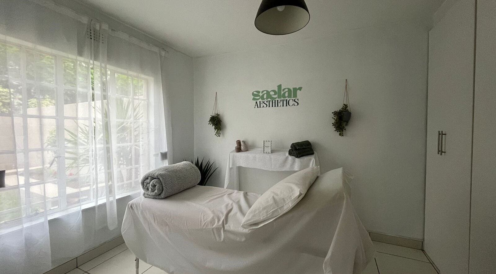 Treatment room at Sælar Aesthetics in Edenvale, Gauteng, ZA, featuring a tranquil setup with natural light.