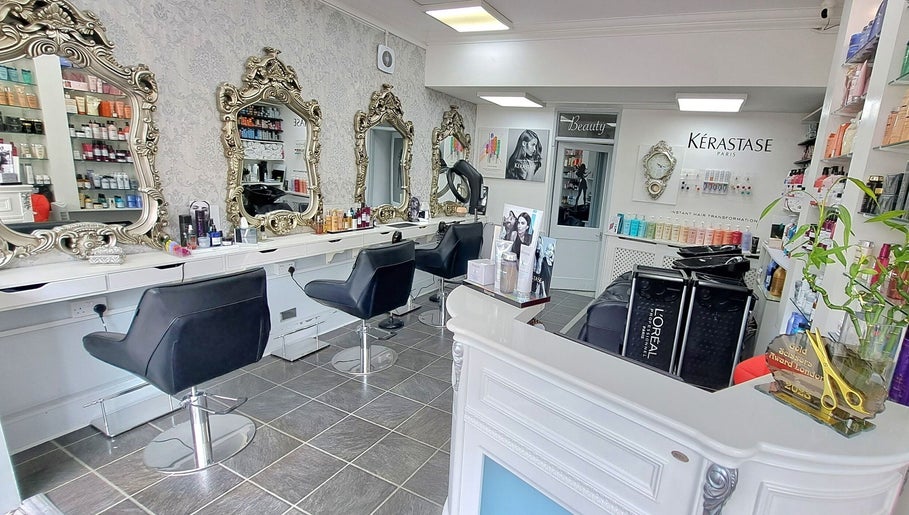 Elegant interior of CC Hair Studio in Oxford, England, GB with ornate mirrors and chic styling chairs.