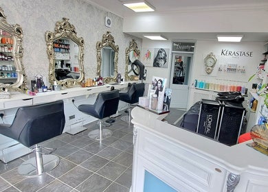 Elegant interior of CC Hair Studio in Oxford, England, GB with ornate mirrors and chic styling chairs.