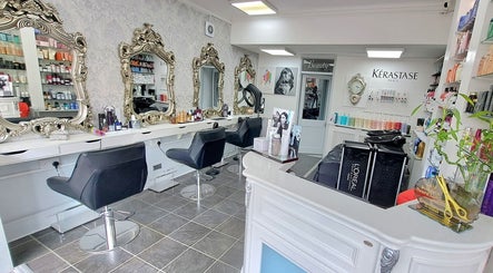 Elegant interior of CC Hair Studio in Oxford, England, GB with ornate mirrors and chic styling chairs.