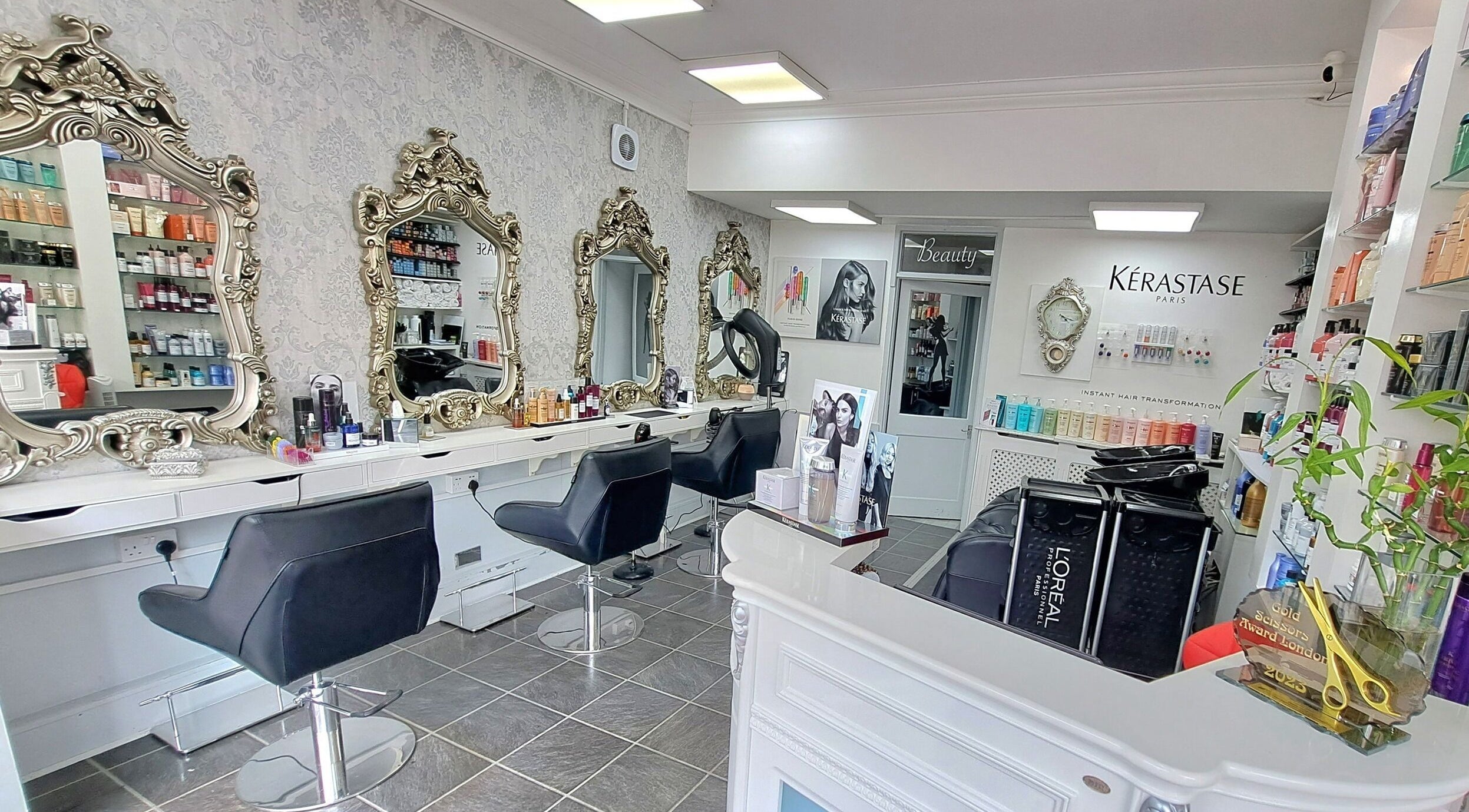 Luxurious interior of CC Hair Studio in Oxford, England, GB featuring ornate mirrors and salon chairs.