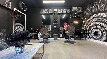 Trendy interior of Rejects Barbers in Boldon Colliery, England, GB with stylish chairs and artwork.