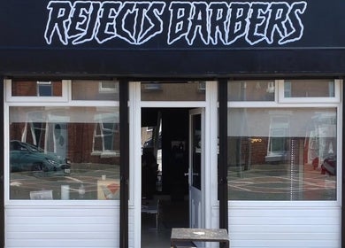 Front entrance of Rejects Barbers in Boldon Colliery, England, GB, featuring modern signage and elegant decor.
