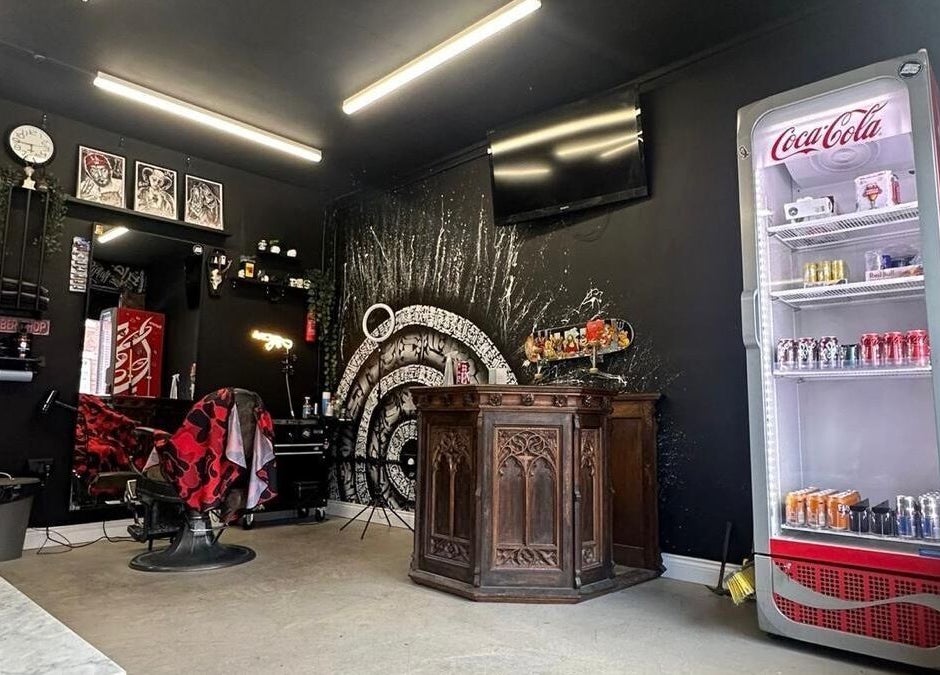 Interior of Rejects Barbers in Boldon Colliery, featuring vintage decor and a stocked Coca-Cola fridge.