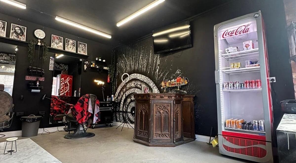 Interior of Rejects Barbers in Boldon Colliery, featuring vintage decor and a stocked Coca-Cola fridge.