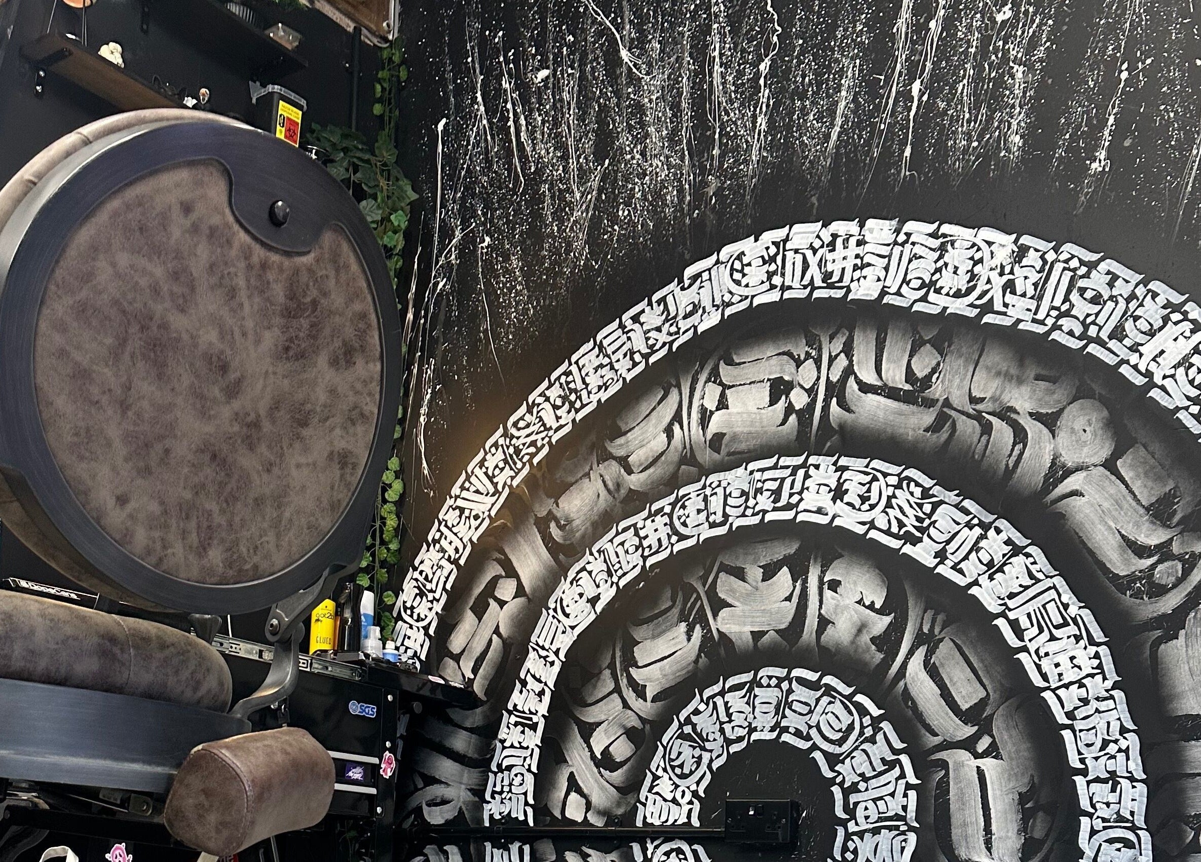 Stylish barber chair and artistic wall design at Rejects Barbers, Boldon Colliery, England, GB.