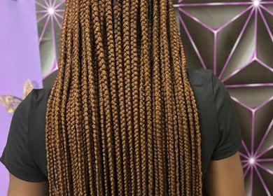 Intricate braided hairstyle at Chan's Unique Hair Studio in Kingstown, St. George, VC, showcasing expert styling.