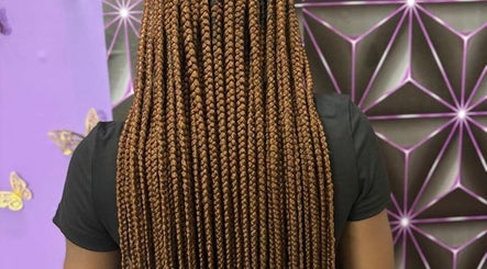 Intricate braided hairstyle at Chan's Unique Hair Studio in Kingstown, St. George, VC, showcasing expert styling.