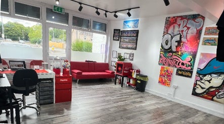 Bright, artistic interior of Concepts Tattoo Limited in Swindon, England, GB with vibrant graffiti on the walls.