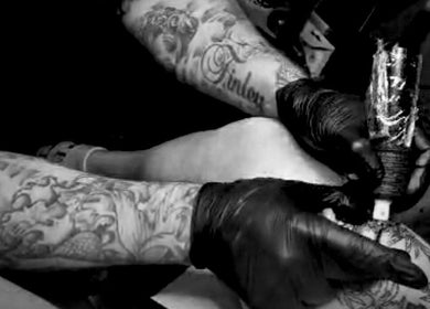Tattoo artist at Concepts Tattoo Limited in Swindon, England, GB, creating intricate body art.