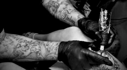 Tattoo artist at Concepts Tattoo Limited in Swindon, England, GB, creating intricate body art.