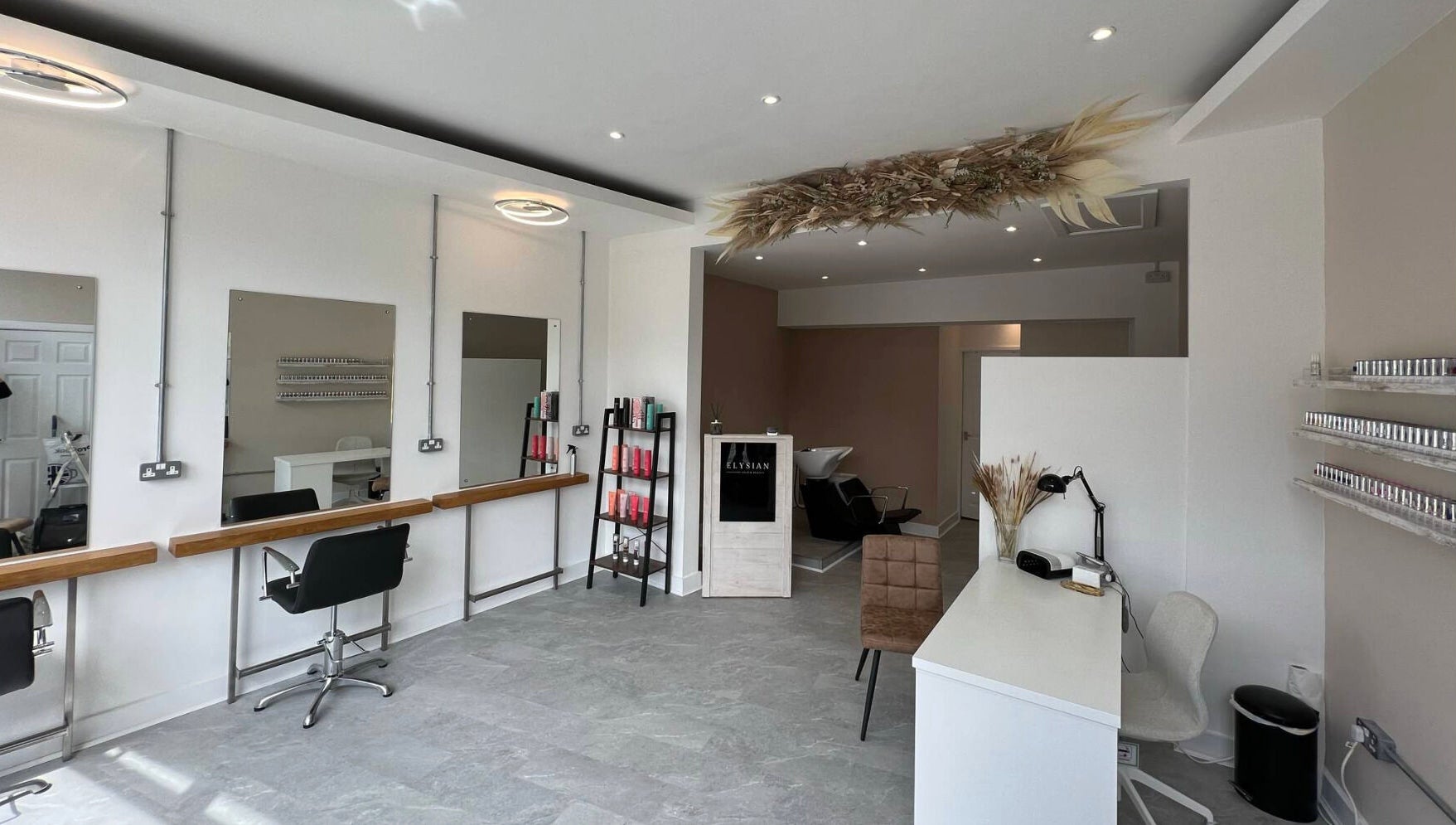 Modern interior of Elysian Hair & Beauty salon in Brighouse, England, GB, showcasing stylish furnishings.