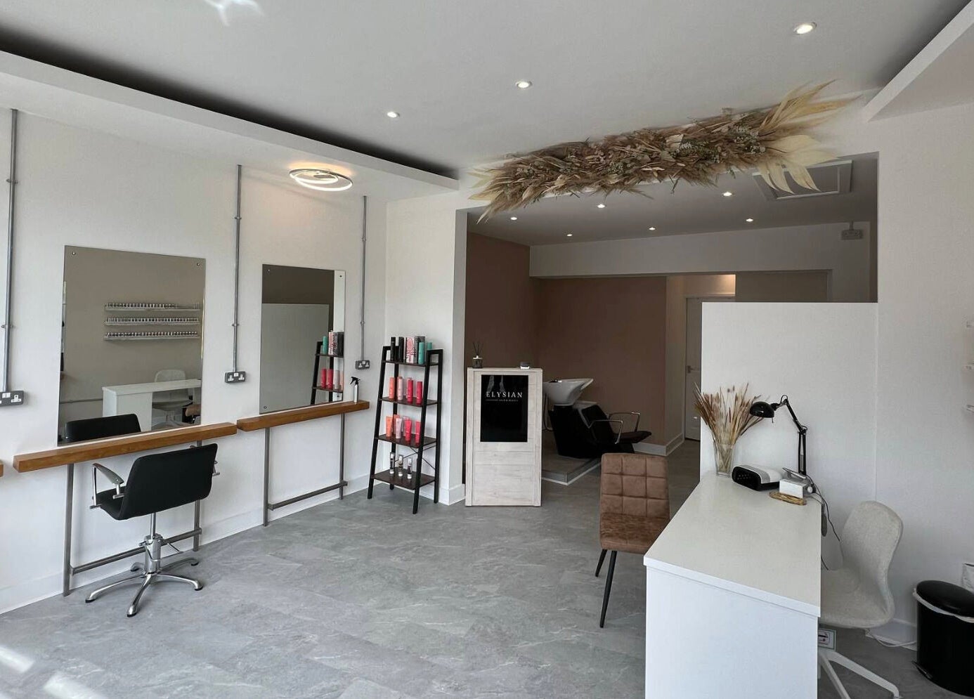 Modern interior of Elysian Hair & Beauty salon in Brighouse, England, GB, showcasing stylish furnishings.