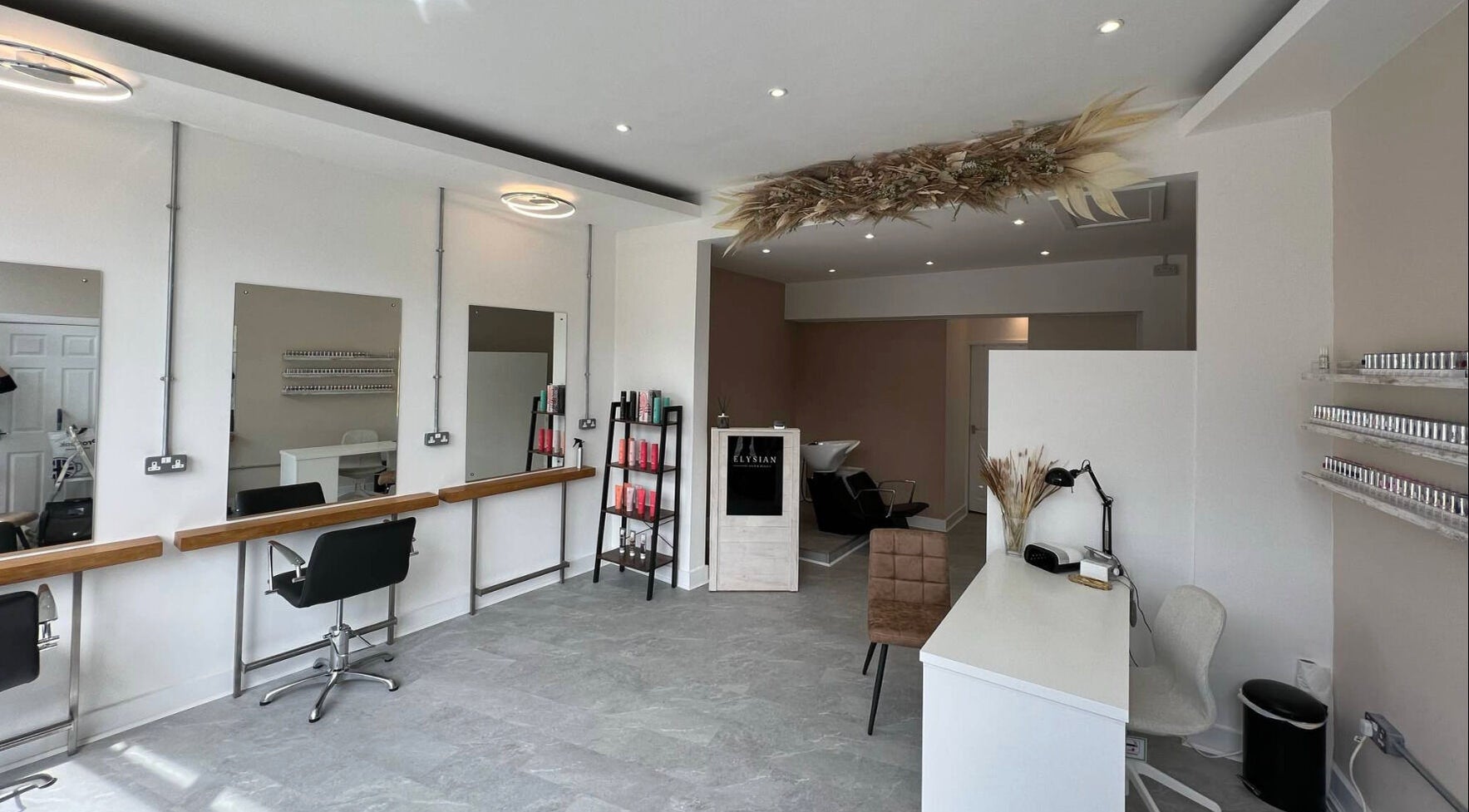 Modern interior of Elysian Hair & Beauty salon in Brighouse, England, GB, showcasing stylish furnishings.