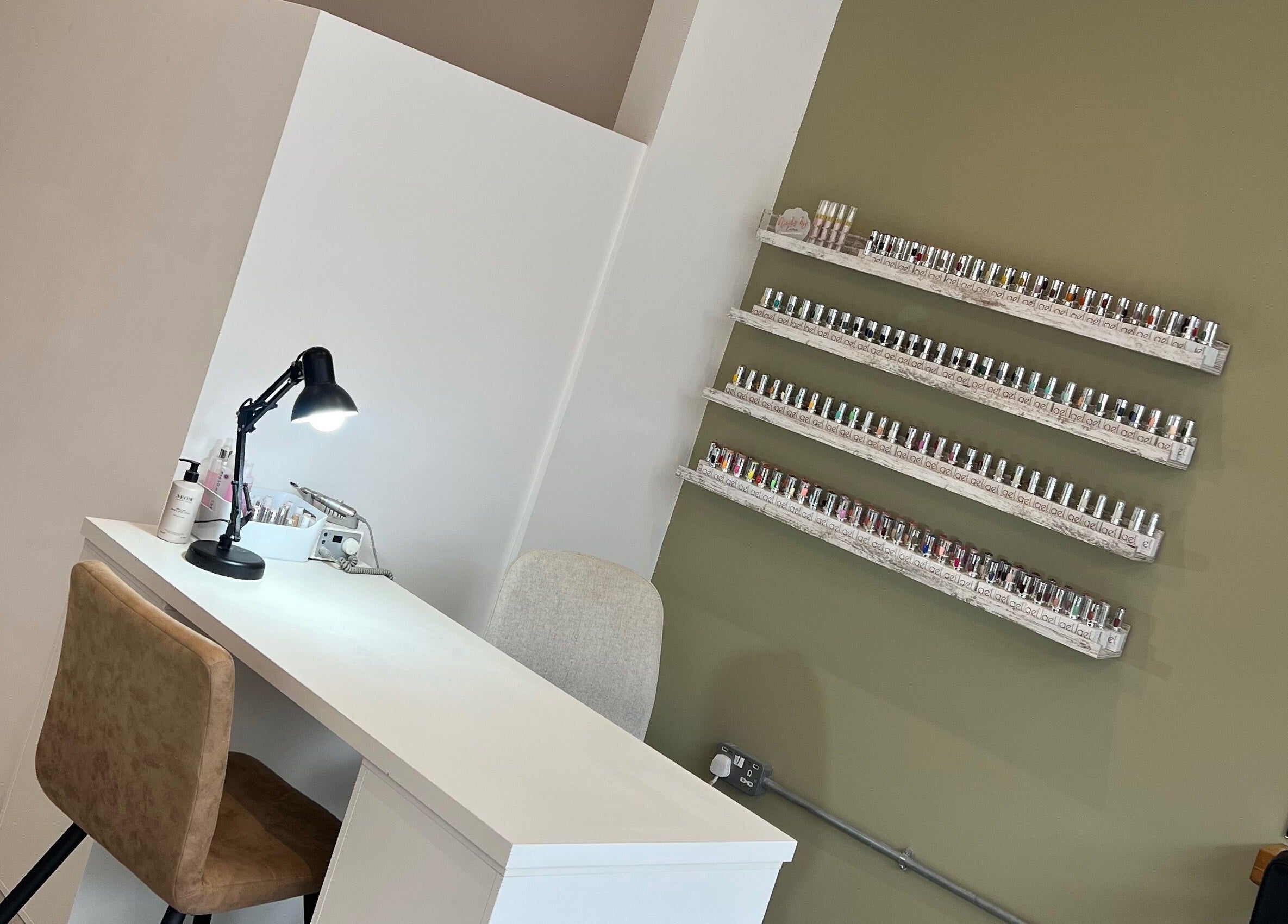 Nail station at Elysian Hair & Beauty in Brighouse, England, GB, featuring an array of nail polishes.