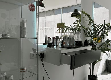 Interior do Sílvio Rodrigues Hair Studio em Amares, Braga, PT, com produtos de beleza e decoração moderna.