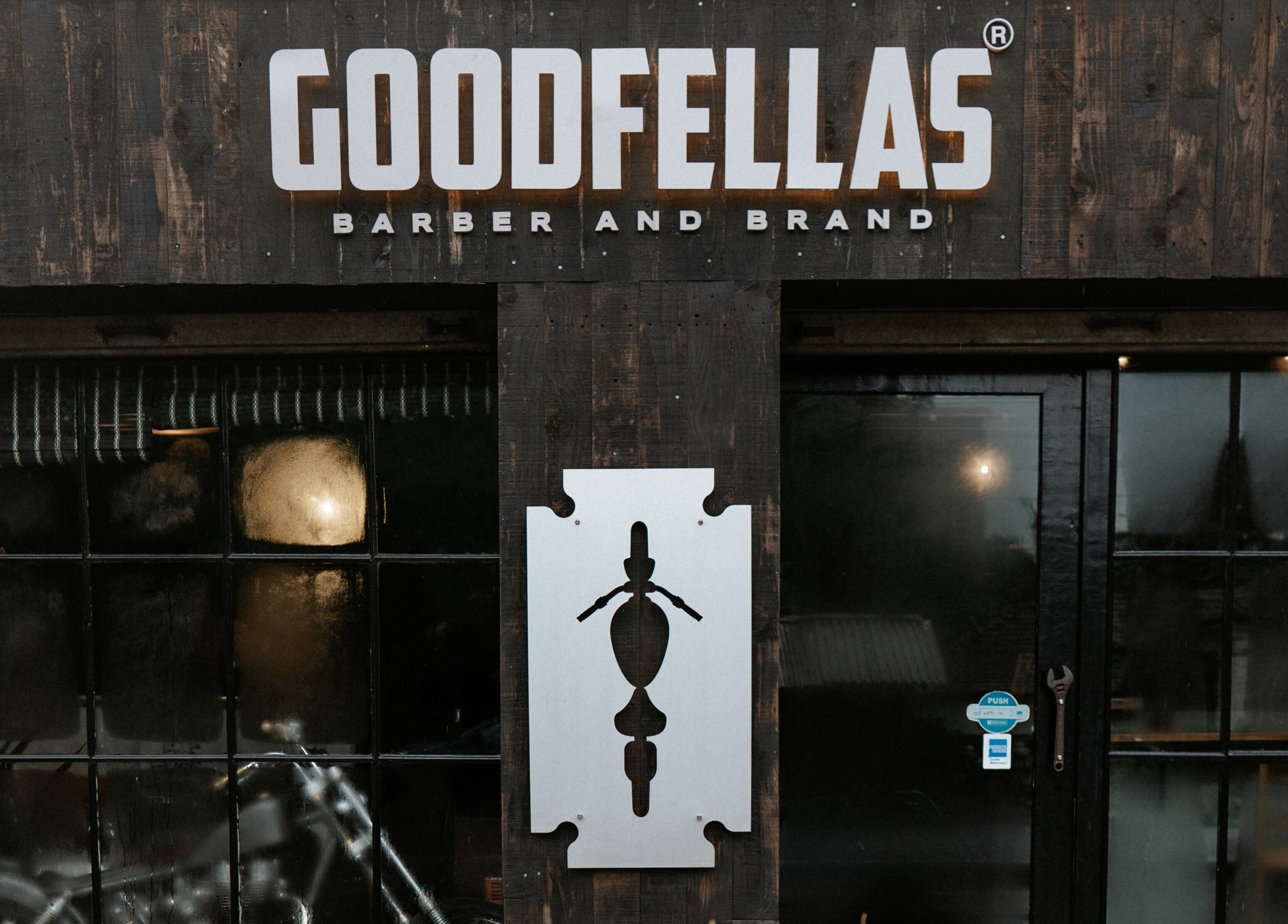 Exterior of Goodfellas Barber & Brand | Est. 2018 in Vagator, Goa, IN with stylish branding.
