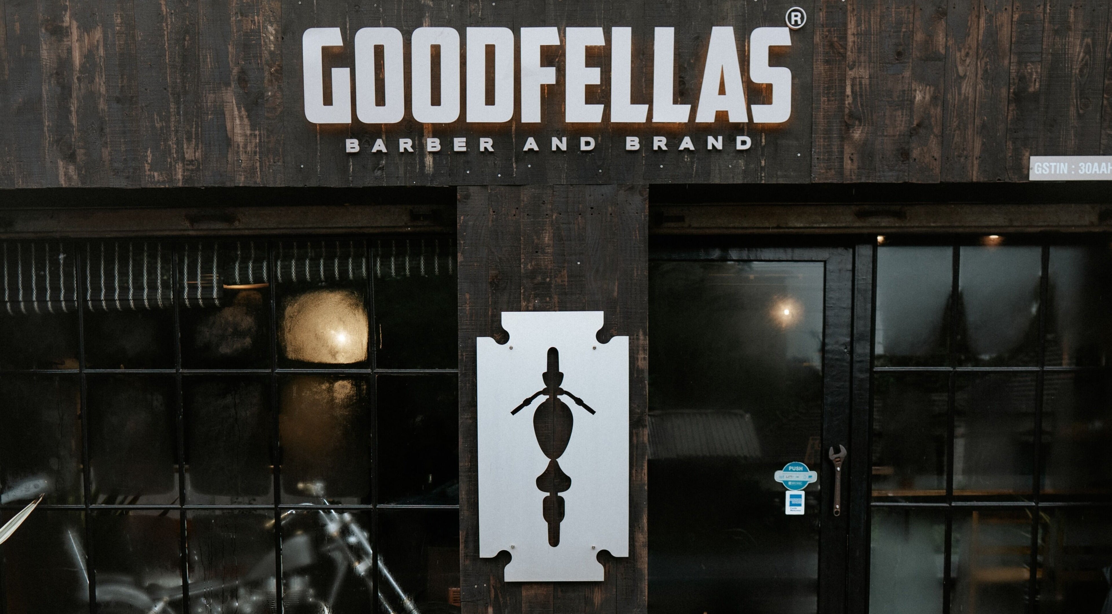 Exterior of Goodfellas Barber & Brand | Est. 2018 in Vagator, Goa, IN with stylish branding.