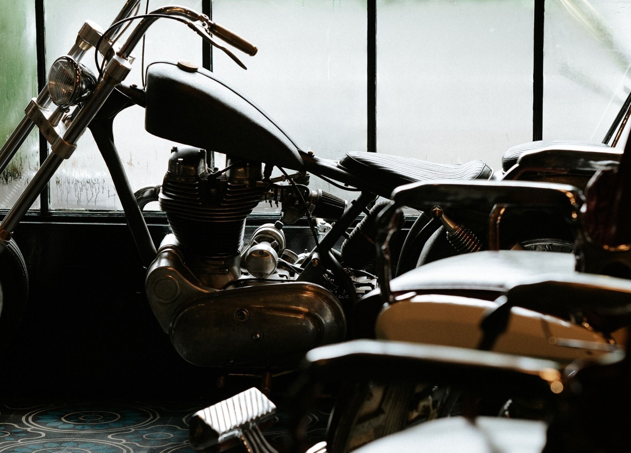 Motorcycle and barber chairs at Goodfellas Barber & Brand | Est. 2018, Vagator, Goa, IN, evoke a classic ambiance.