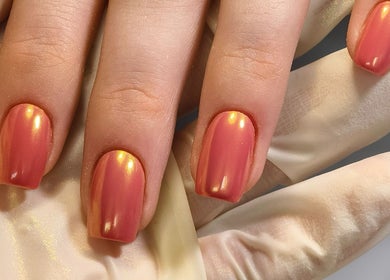 Stunning glossy coral nails at Kyuote_Nails in Rīga, LV, showcasing meticulous detail and elegance.